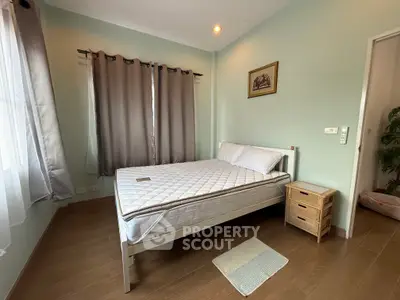 Cozy bedroom with natural light, featuring a comfortable bed and stylish decor, perfect for relaxation.