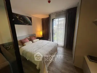 Cozy bedroom with modern decor and natural light from large window