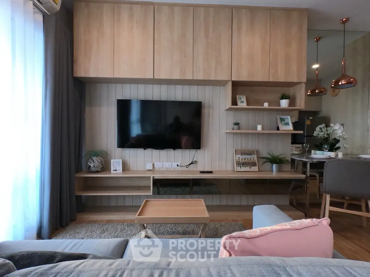 Modern living room with stylish wooden TV unit and cozy seating area