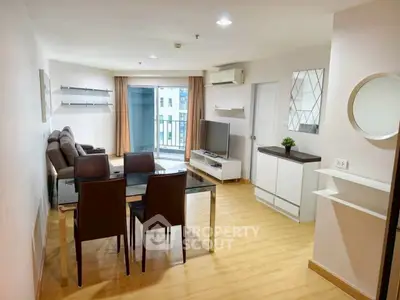 Spacious modern living room with dining area and balcony access in a stylish apartment.