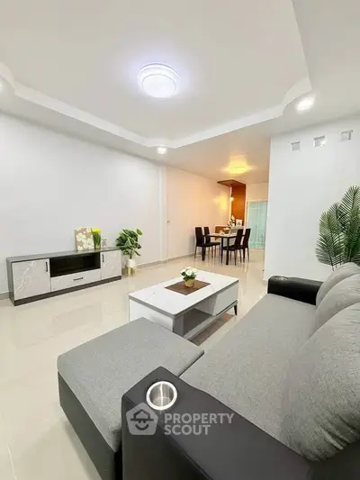 Spacious modern living room with elegant decor and dining area, perfect for family gatherings.