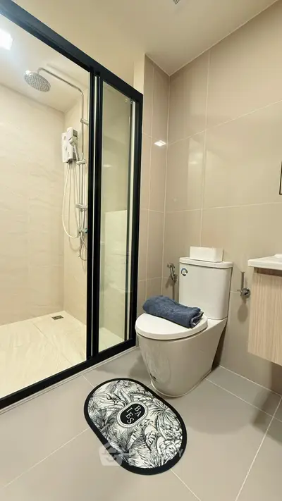 Modern bathroom with sleek shower and elegant fixtures in contemporary apartment.