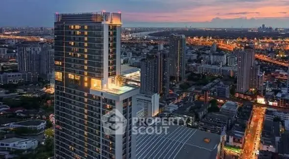 Stunning high-rise building with cityscape view at sunset, perfect for urban living.