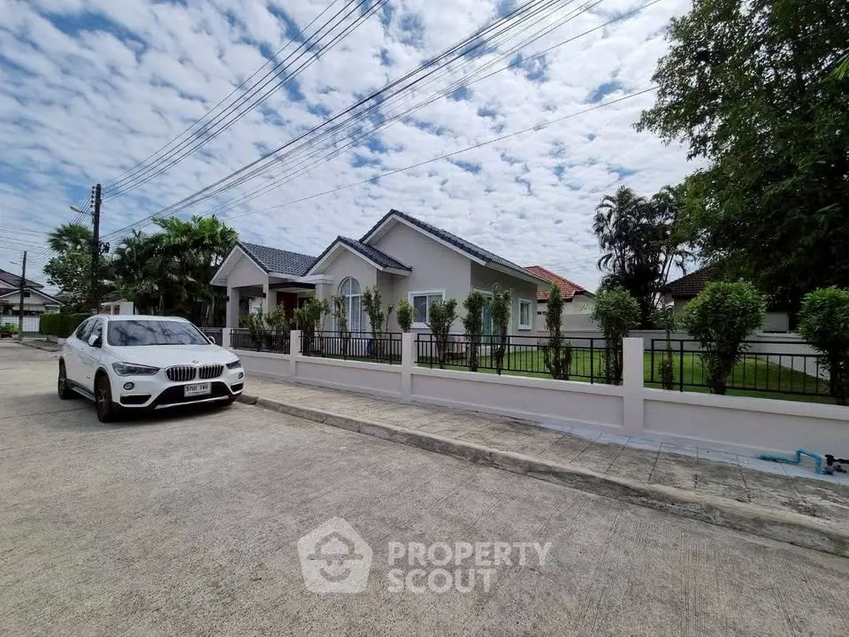 Charming suburban house with lush garden and driveway, perfect for family living.