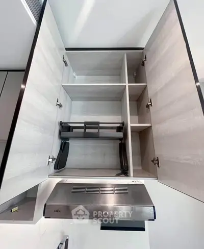 Modern kitchen cabinet with built-in range hood and sleek design