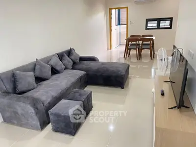 Modern living room with plush gray sectional sofa and sleek TV setup