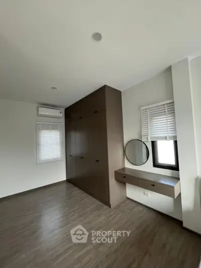 Spacious bedroom with built-in wardrobe and modern decor
