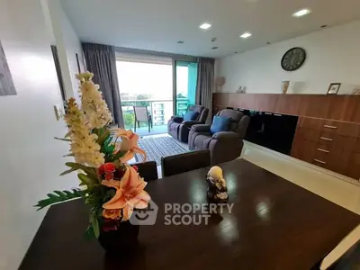 Spacious living room with modern decor and balcony view in a stylish apartment.