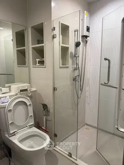 Modern bathroom with glass shower enclosure and sleek fixtures