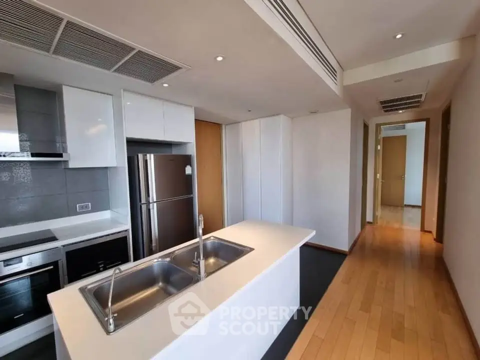 Modern kitchen with sleek appliances and island in a spacious apartment