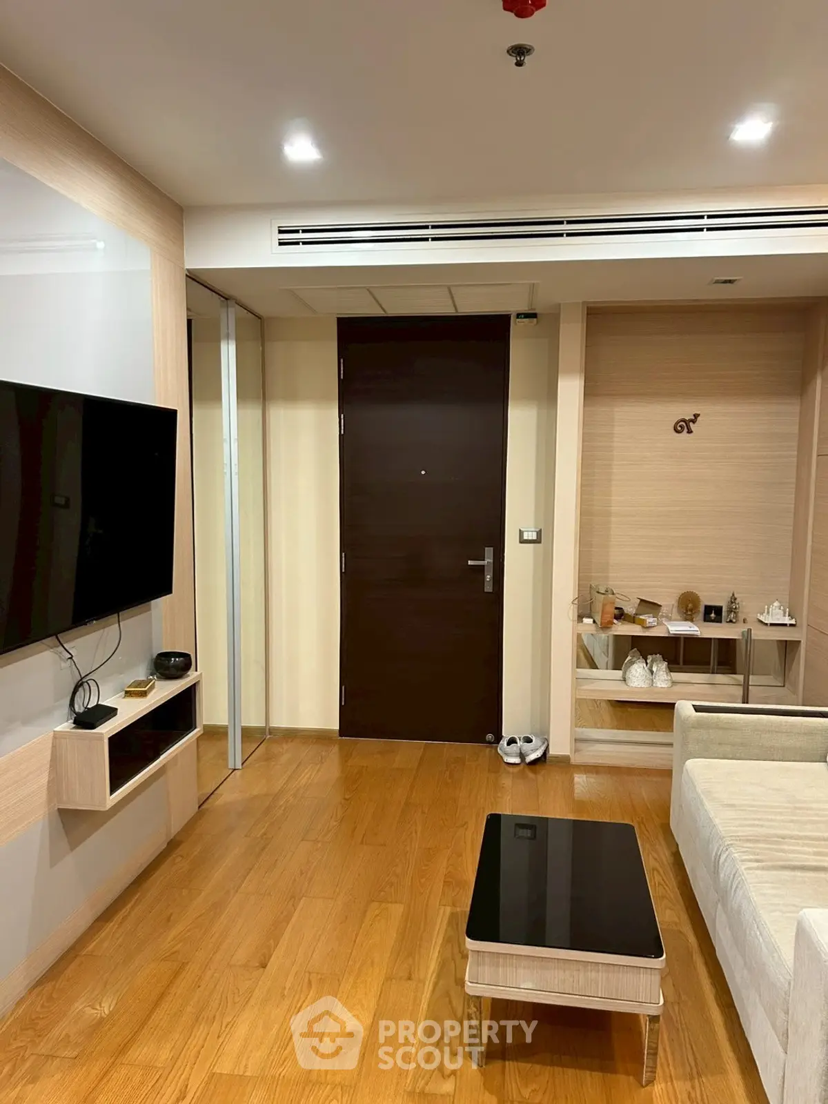 Modern living room with wooden flooring and sleek furniture