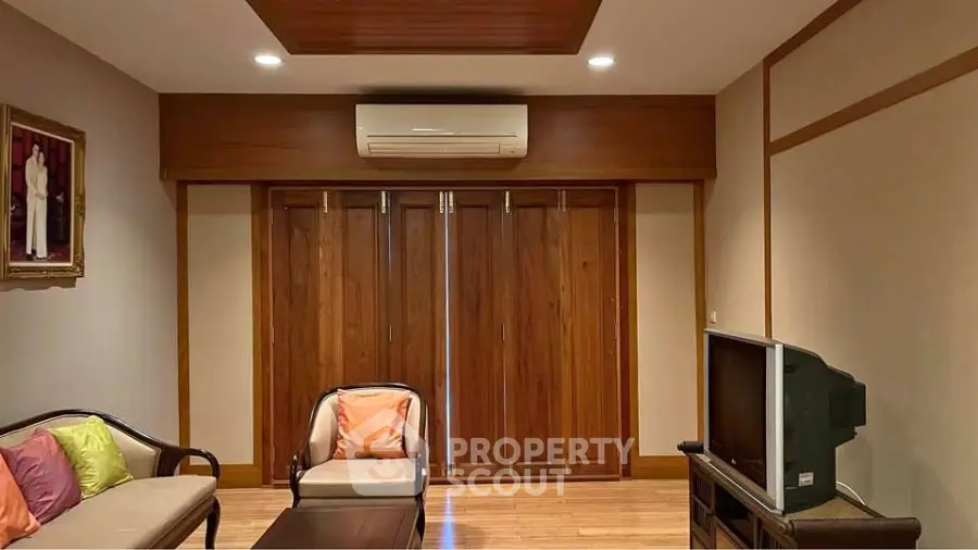 Cozy living room with wooden accents and modern air conditioning unit.