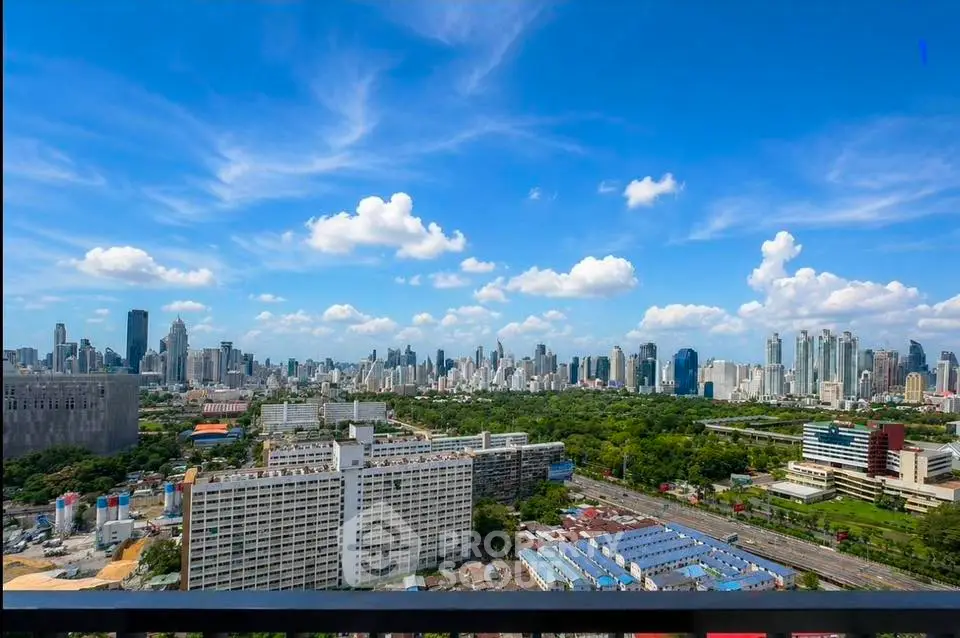 Stunning cityscape view from high-rise balcony with lush greenery and skyline
