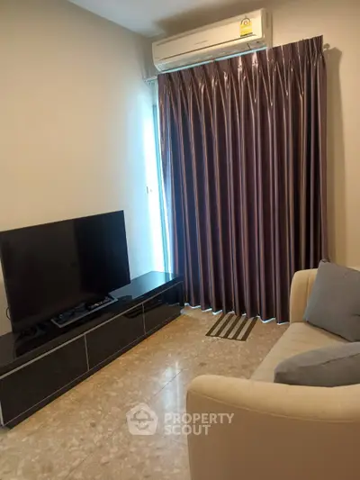 Cozy living room with modern TV setup and elegant curtains