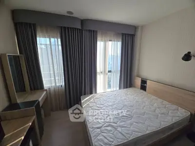 Modern bedroom with large windows and stylish curtains, featuring a comfortable bed and sleek furniture.