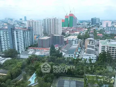 Stunning cityscape view from high-rise building showcasing urban living and green spaces.