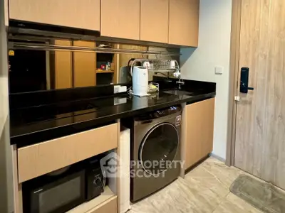 Modern kitchen with sleek cabinetry, built-in appliances, and stylish black countertops.