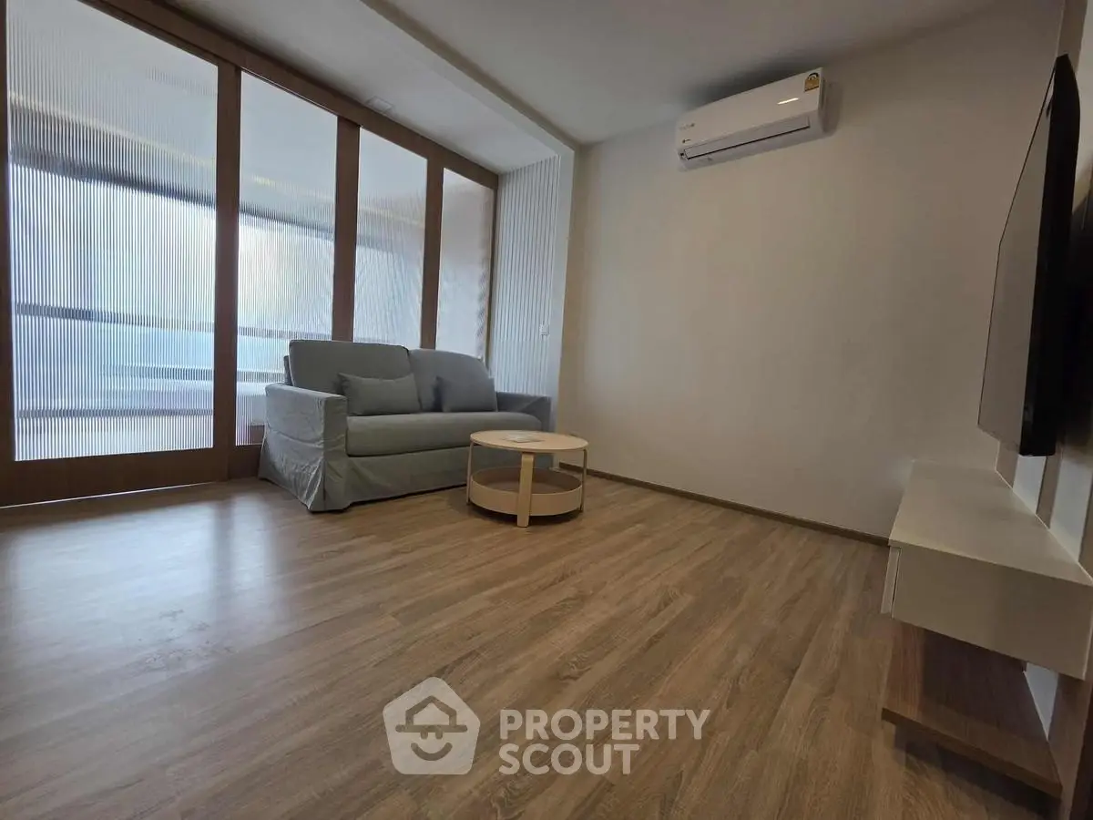 Modern living room with sleek air conditioning and cozy sofa