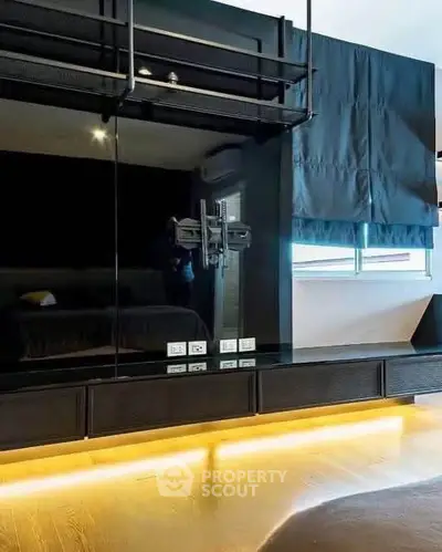 Modern bedroom with sleek black design and ambient lighting