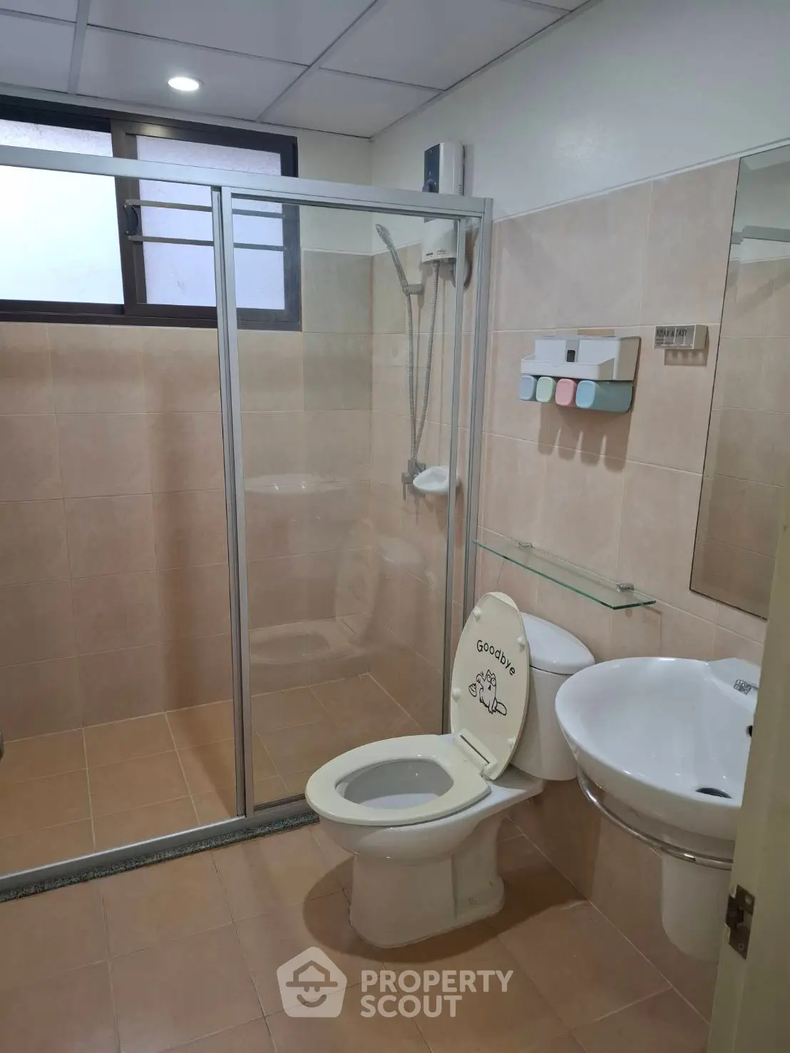 Modern bathroom with glass shower enclosure and sleek fixtures