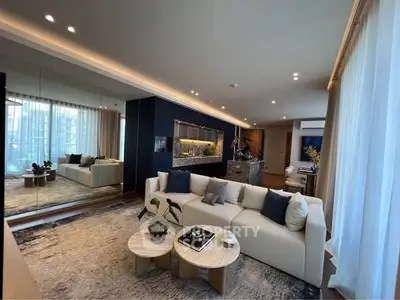 Luxurious living room with modern decor, large mirror, and elegant lighting.