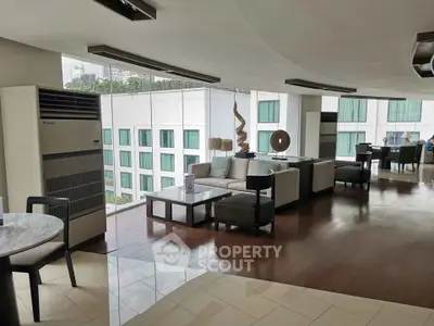 Spacious modern living room with large windows and stylish furniture