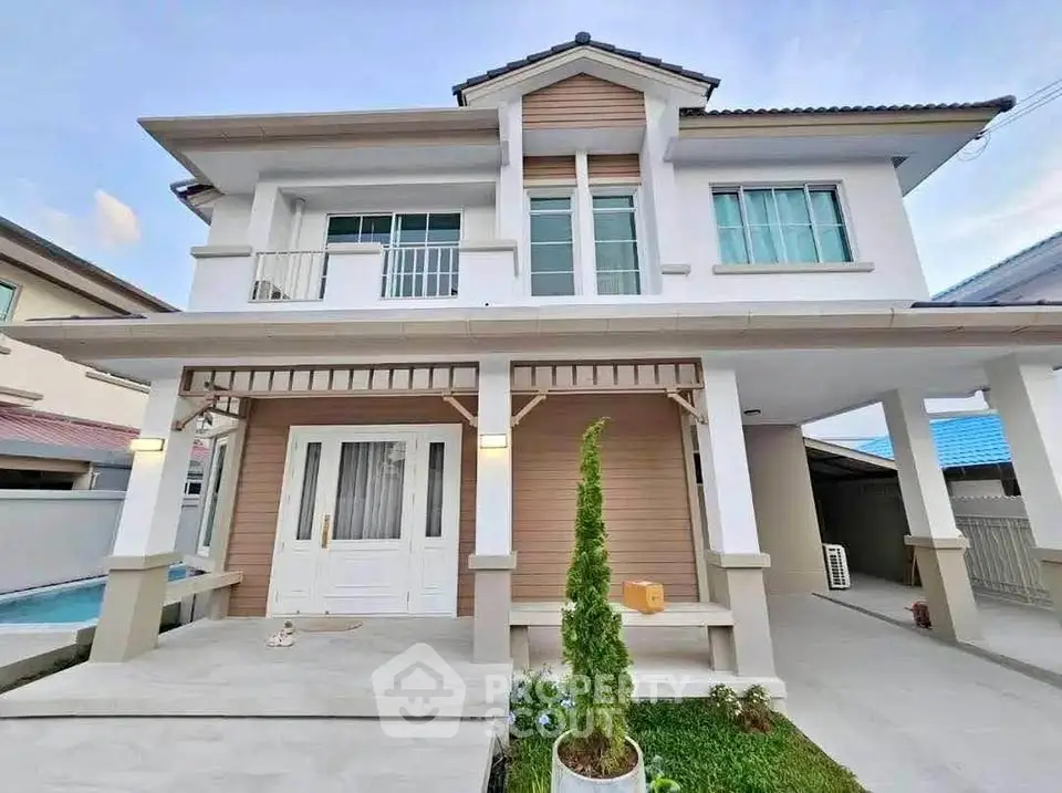 Stunning modern two-story house with elegant facade and spacious driveway.