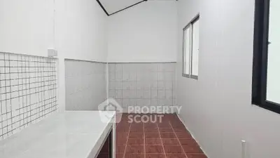 Spacious tiled room with large windows and modern design, perfect for versatile use.