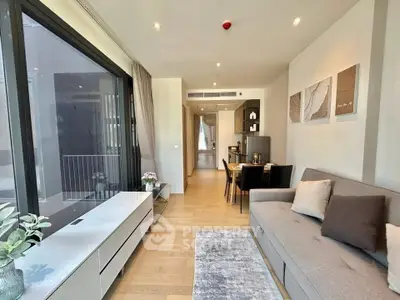 Modern living room with sleek design and large windows in a contemporary apartment.