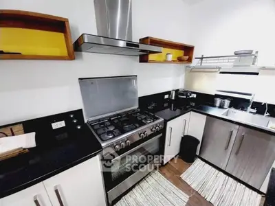 Modern kitchen with sleek black countertops and stainless steel appliances