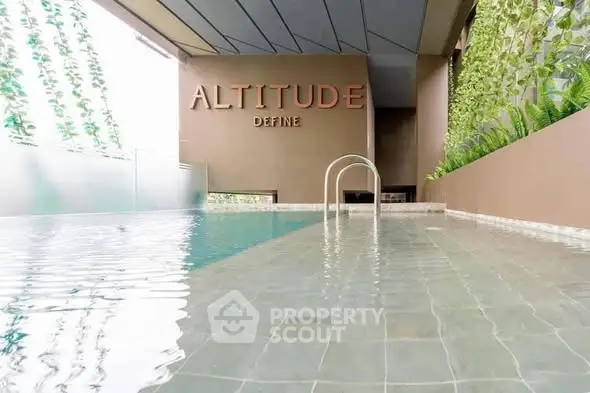 Luxurious rooftop pool with modern design and lush greenery at Altitude Define.