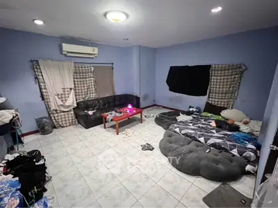 Spacious living room with air conditioning and cozy seating area.