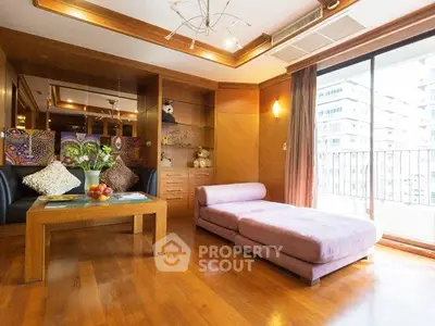 Spacious living room with wooden floors and large windows in modern apartment