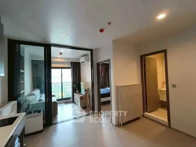 Modern apartment interior with open layout, featuring a cozy living room and a glimpse of the bedroom.