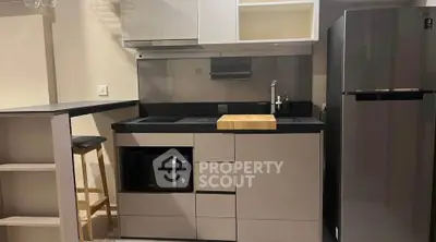 Modern compact kitchen with sleek cabinetry and appliances