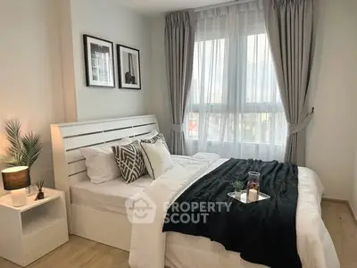 Cozy bedroom with modern decor and large window for natural light