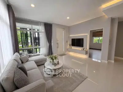 Modern living room with sleek design, large windows, and stylish furniture in a contemporary home.