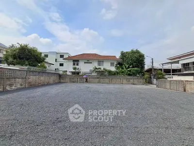Spacious vacant lot with potential for development in a residential neighborhood.