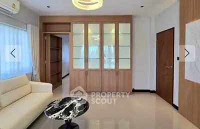 Modern living room with elegant furniture and built-in wooden cabinets