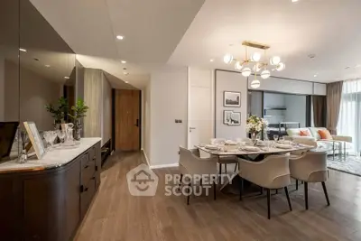 Luxurious open-plan dining and living area with elegant decor and modern lighting.
