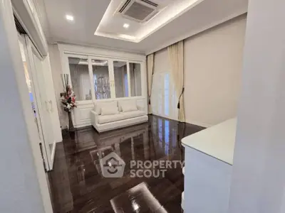 Elegant living room with glossy wooden floors and modern decor