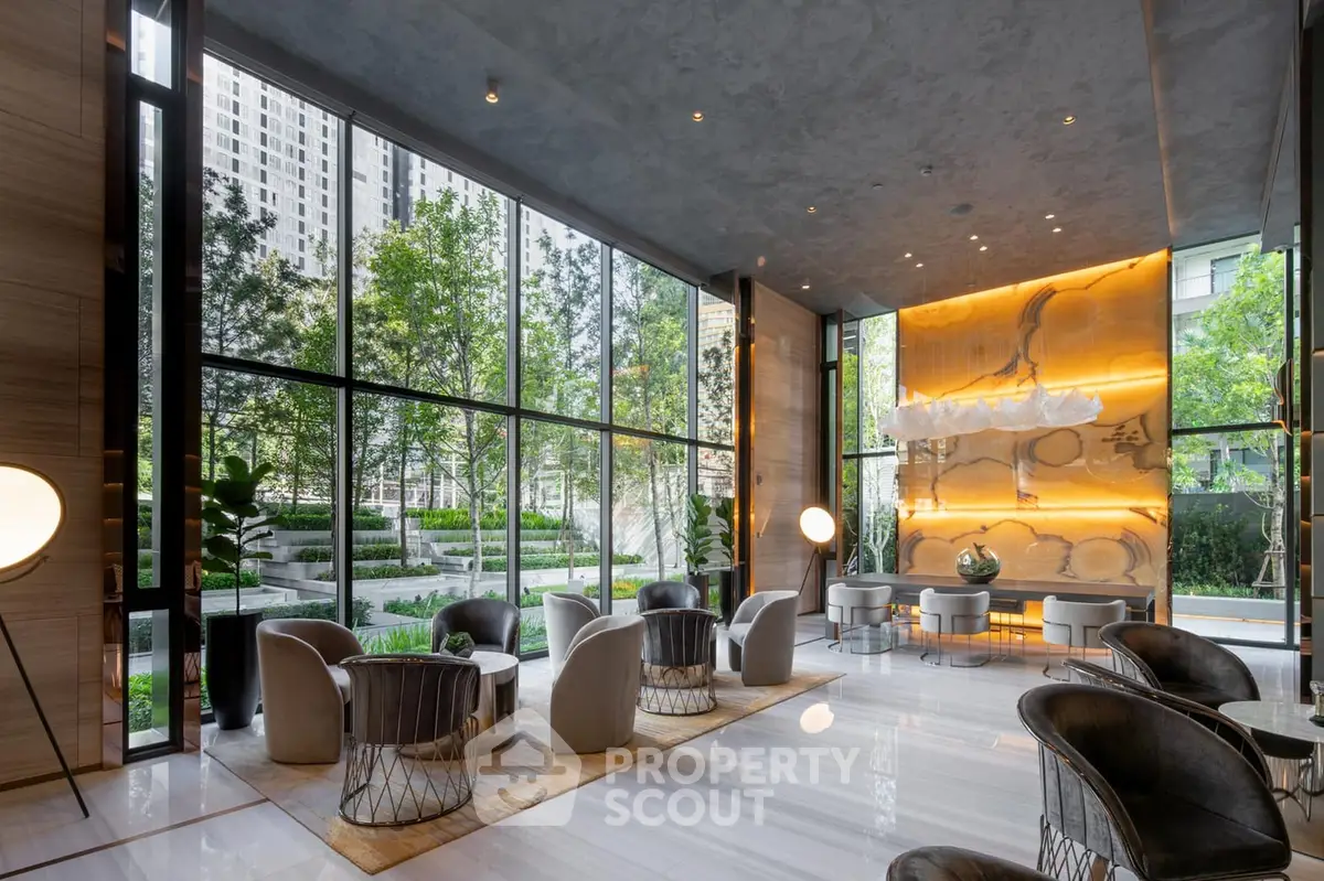 Luxurious modern lobby with floor-to-ceiling windows and elegant seating area.