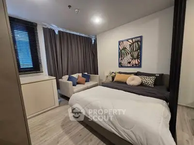 Cozy modern bedroom with stylish decor and comfortable seating area