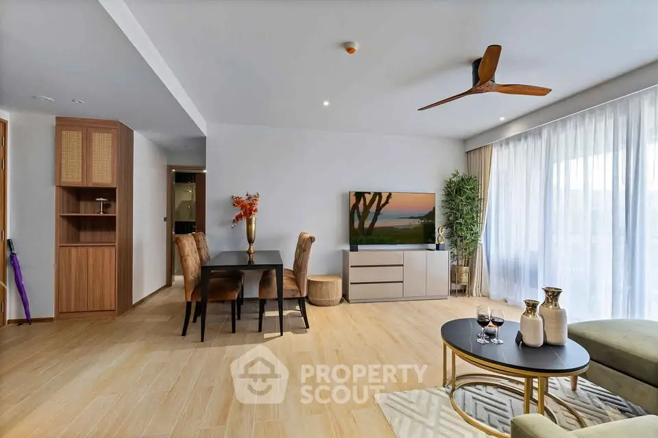 Spacious modern living room with elegant dining area and large windows