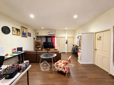 Spacious living room with modern decor and wooden flooring