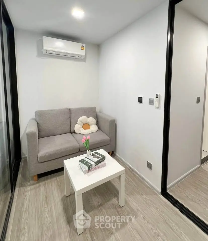 Cozy living room with modern sofa and air conditioning in a stylish apartment.