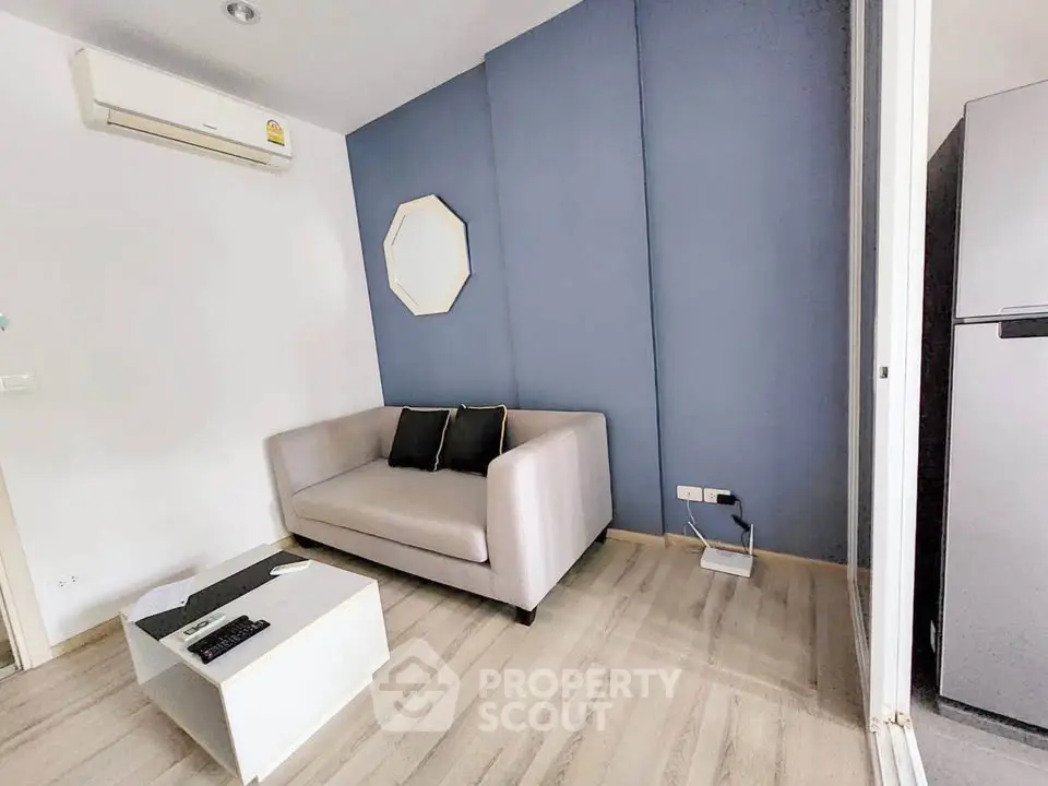 Modern living room with sleek sofa and air conditioning in stylish apartment.
