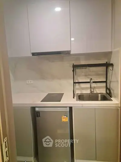 Modern compact kitchen with sleek cabinets and stainless steel appliances