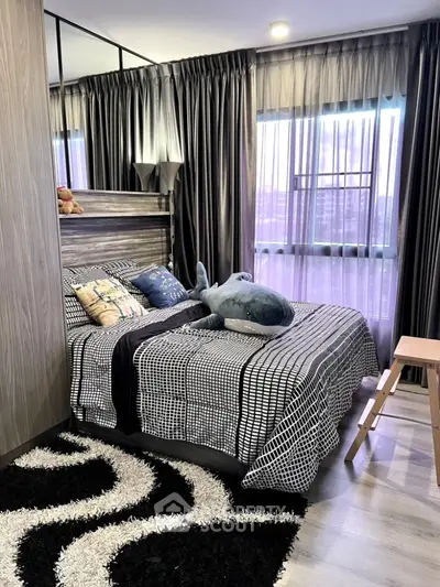 Stylish bedroom with modern decor and large windows for natural light.