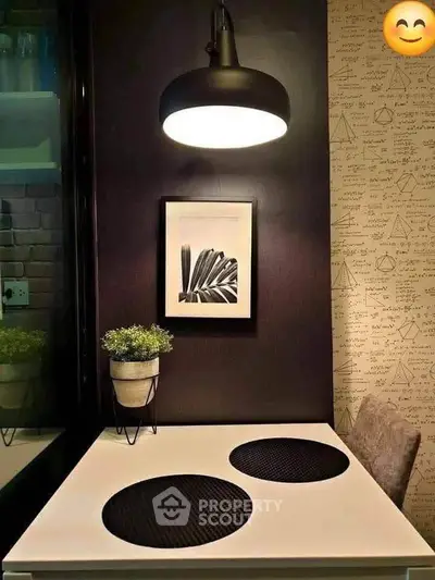 Stylish modern dining nook with elegant lighting and artistic decor